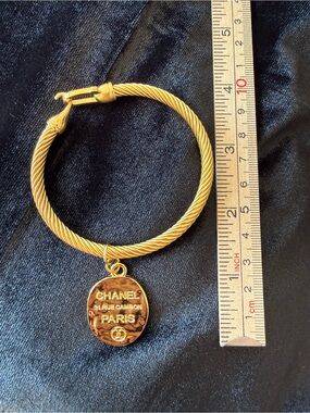 Gold-Tone Twisted Bracelet with CHANEL Paris Pendant